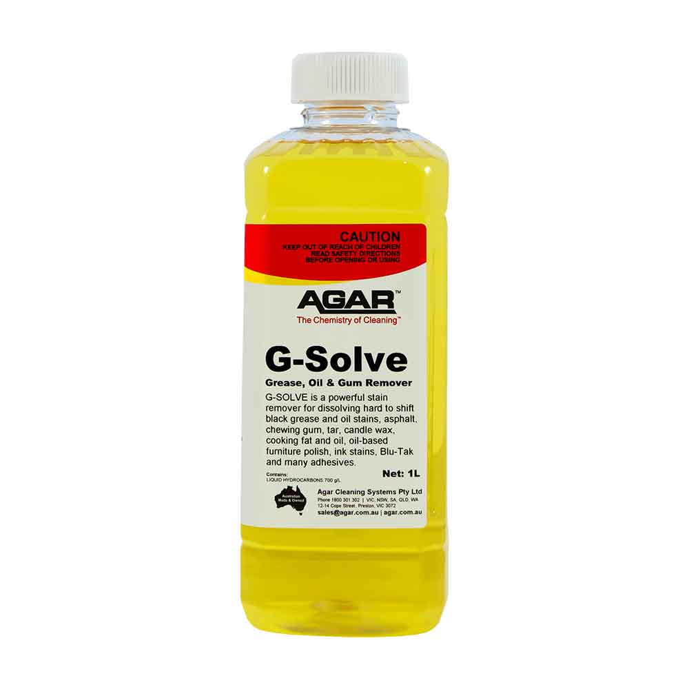 A yellow plastic bottle of Agar G-Solve Grease, Oil & Gum Remover with product information and branding visible.